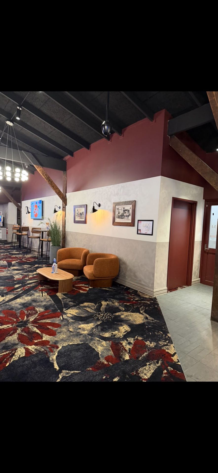 A refined interior with warm burgundy feature wall and Venetian plaster finish